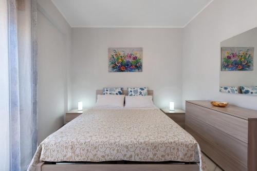 a bedroom with a bed and two paintings on the wall at Stella Del Sud in Squinzano