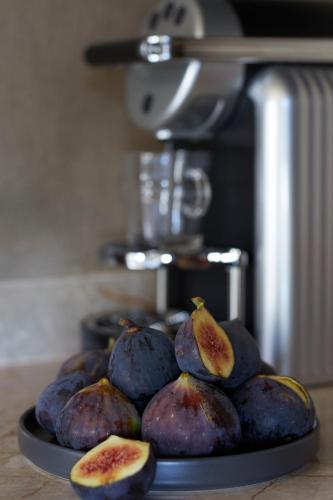 a plate of fruit on top of a counter at Santorini Sky, The Lodge in Pyrgos