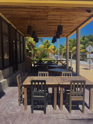 a wooden table and chairs on a patio at Hotel Luna De Plata in Mahahual