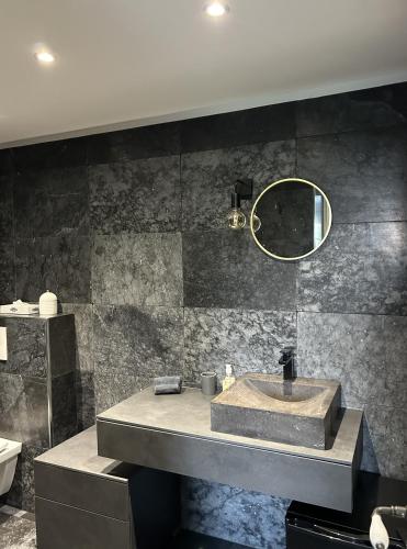 a bathroom with a sink and a mirror at Des Ciappes et des Fées in Menton