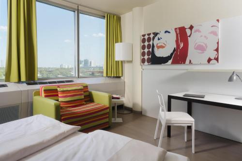 a hotel room with a bed and a desk and a chair at harry's home Wien hotel & apartments in Vienna