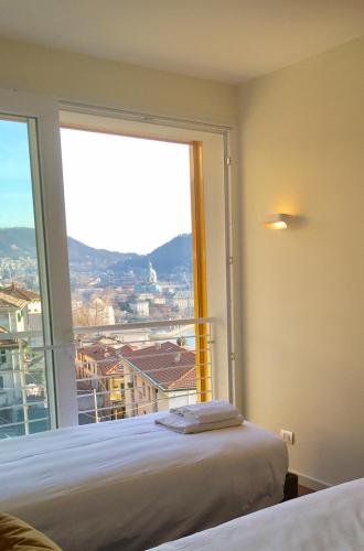 a bedroom with a large window with a view at Executive Penthouse Como Condo sleeps 5 by Italian Apartments in Como