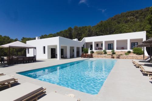 a villa with a swimming pool and a resort at Villa Arenas in Sant Josep de sa Talaia