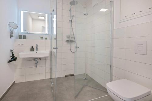 a bathroom with a shower and a toilet and a sink at An der Haffküste Haffkoje in Zirchow