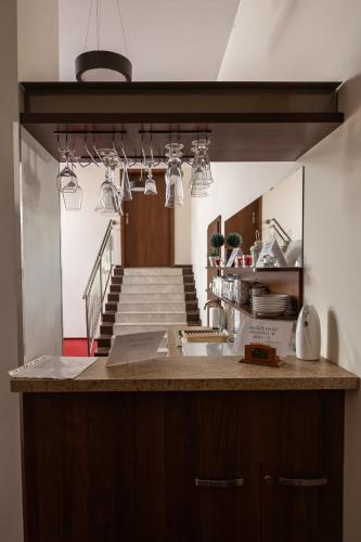 a kitchen with a counter with a sink and a staircase at Dom Weselny Perła Warmii in Lidzbark Warmiński