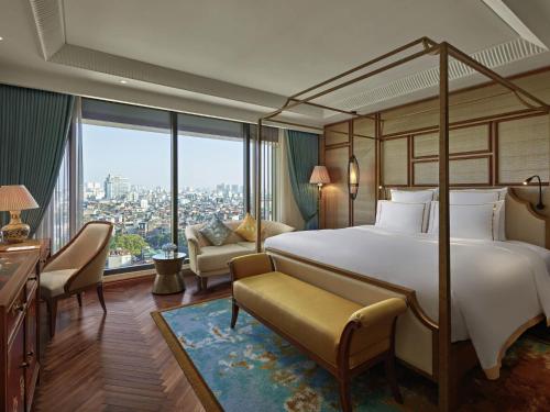 a hotel room with a bed and a large window at Grand Mercure Hanoi in Hanoi