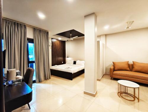 a living room with a bed and a couch at The Core in Kohīma