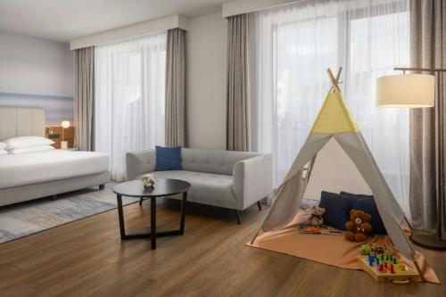 a living room with a bed and a play tent at Sheraton Nice in Nice