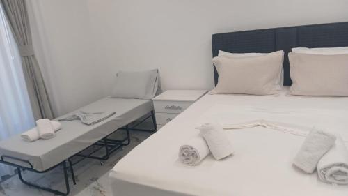 a bedroom with a white bed and a desk at Horizon Crown Rooms Ulcinj in Briska Gora