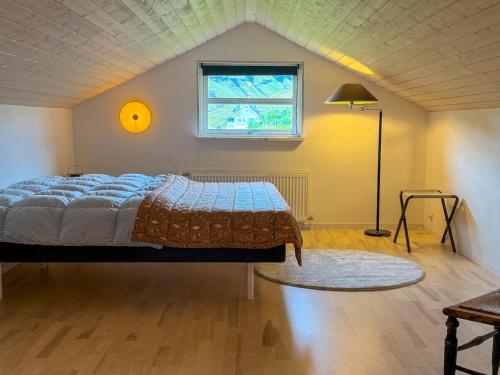 a bedroom with a bed and a window at Sea & Mountain View 4 Bedroom in Leynar