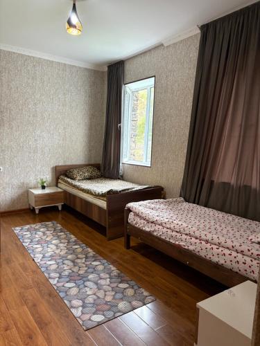 a bedroom with two beds and a window at Guest House koshki in Iprari