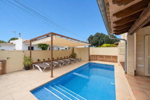 a swimming pool in the backyard of a house at Ca S'Ingles in Alcudia