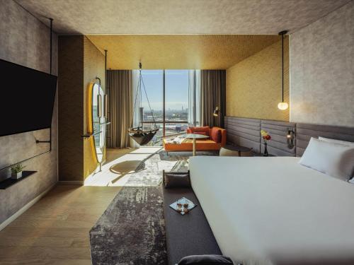 a hotel room with a bed and a living room at Novotel Mexico City Toreo in Mexico City
