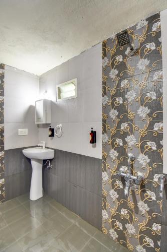 a bathroom with a sink and a toilet in a room at Orange Vista Resort Coorg in Kushālnagar