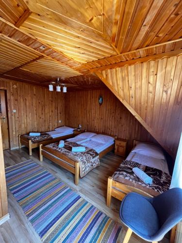 a room with three beds in a wooden cabin at Wypoczynek u Hajnosa in Białka Tatrzańska