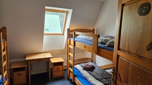 a room with two bunk beds and a window at Ski park Gruň in Staré Hamry