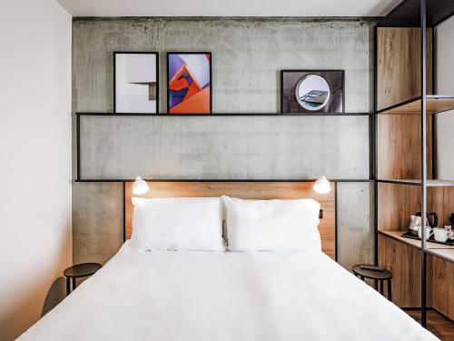 a bedroom with a large bed and shelves at ibis Bridgwater, M5 Jct23 in Bridgwater