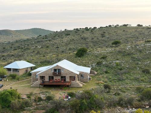 a house on the side of a hill at Shama Private Group Lodge in Steytlerville