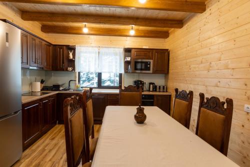 a kitchen with a table with a vase on it at Cabana Magura Mare Belis in Călăţele