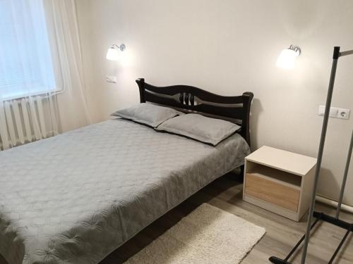 a bedroom with a bed and a table and a window at Шепіт Річки in Mizhhirya