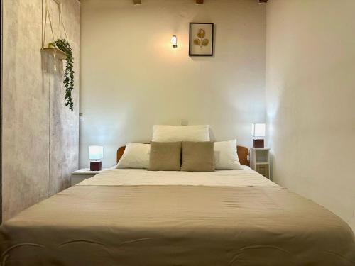 a bedroom with a large bed with two pillows at Damir Apartments Bonina in Jelsa