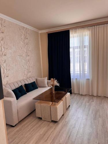 a living room with a couch and a coffee table at Liga Hotel and Restaurant in Shinuhayr