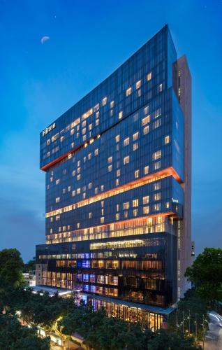 a rendering of a building with lights on at Hilton Guangzhou Tianhe in Guangzhou