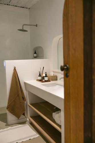a bathroom with a white sink and a mirror at The Oak Cottage in Wellington