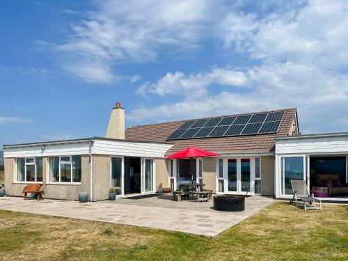 a house with solar panels on the roof at Driftwood in Mainsriddle