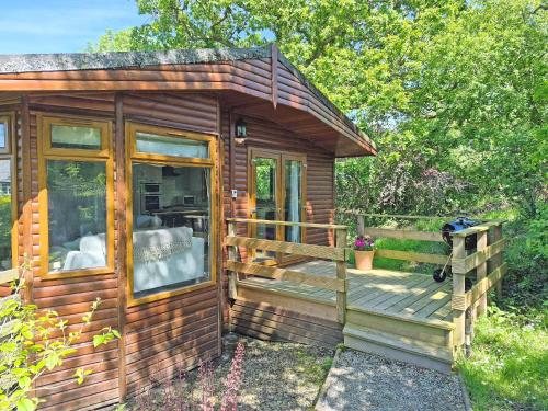 a wooden cabin with a porch and a deck at Torridge Lodge - Ukc9517 in Sheepwash