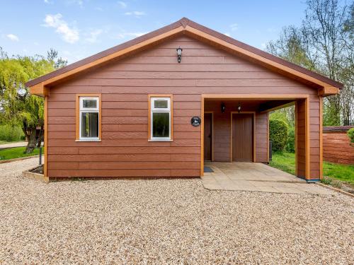 a red garage with a door in a driveway at Teal - Uk41036 in Marston