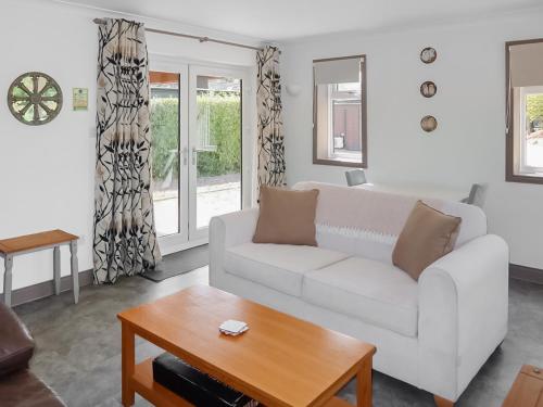 a living room with a white couch and a table at Teal - Uk41036 in Marston