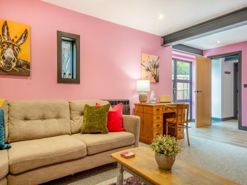 a living room with a couch and a table at The Hideaway in Yarmouth