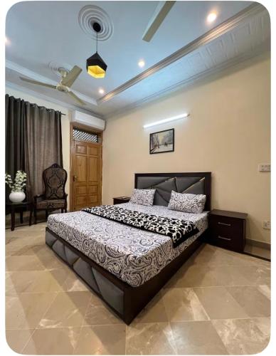 a bedroom with a large bed in a room at 4Bdr Spacious Hill View Central E 11 TV Netflix in Islamabad