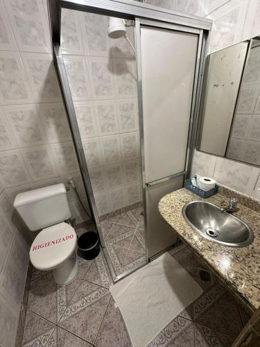 a bathroom with a toilet and a sink at Pousada Mineira in Ouro Preto