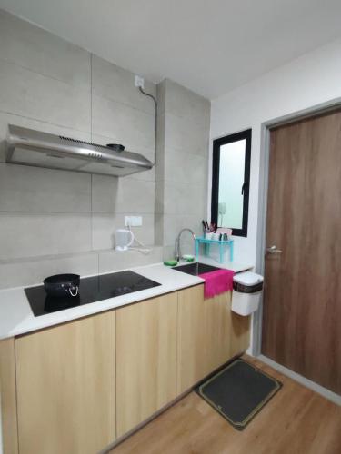 a kitchen with a sink and a counter top at Hann's Avenue Suites - Heart of Sibu - Free Parking in Sibu