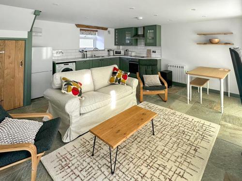 a living room with a couch and a table at The Mill House Uk47418 in Curry Mallet