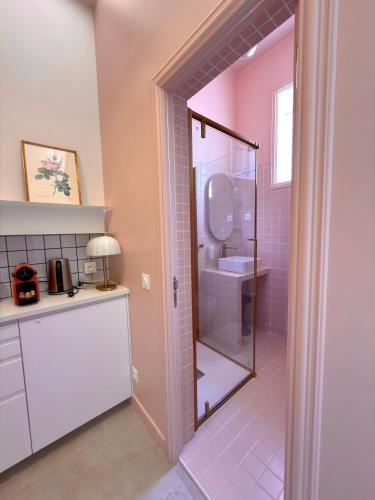 a bathroom with a shower with a toilet and a sink at La Boîte Rose - Studio plage de l'Almanarre in Hyères