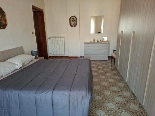 a bedroom with a bed and a dresser in it at la casa di LILLY con wi fi in Avellino