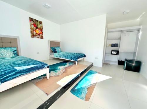 a bedroom with two beds and a tv at Under the sea diving resort in Lapu Lapu City