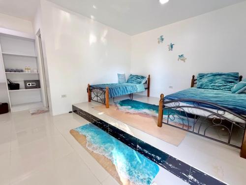 two beds in a room with a pool on the floor at Under the sea diving resort in Lapu Lapu City
