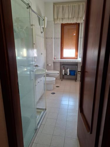 a bathroom with a glass shower and a toilet at la casa di LILLY con wi fi in Avellino
