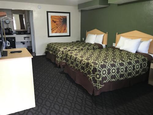 a hotel room with two beds and a table at Downtown Inn in Eugene