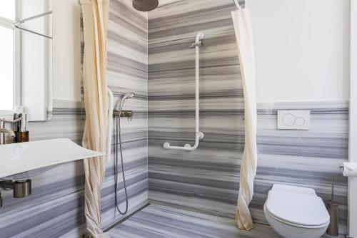 a bathroom with a shower and a toilet at Villa Rossella in Locarno