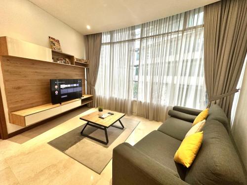 a living room with a couch and a tv at Sky Apart-Hotel klcc in Kuala Lumpur
