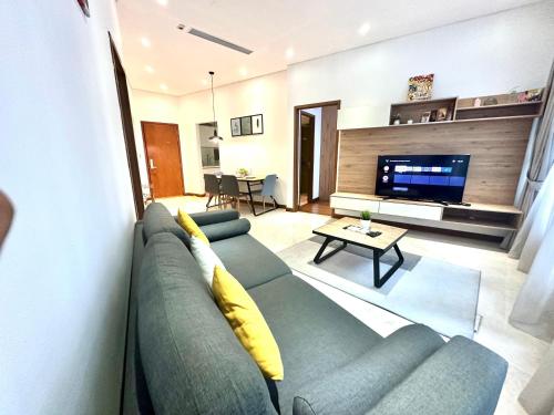 a living room with a couch and a television at Sky Apart-Hotel klcc in Kuala Lumpur