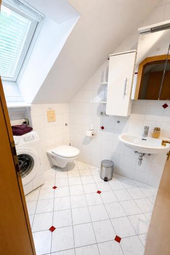 a white bathroom with a sink and a toilet at Schlossapartments Wolfsberg in Wolfsberg