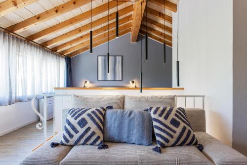 a living room with a couch with pillows on it at Osteria Ascona in Ascona