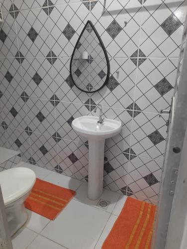 a bathroom with a sink and a toilet at Hostel Família Carvalho in Barreirinhas