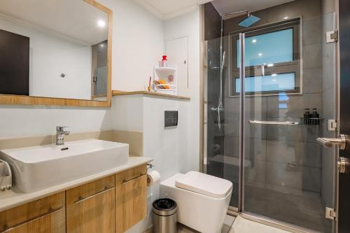 a bathroom with a sink toilet and a shower at NEW Beachfront 3-bedrooms Apartment in Tamarin, Ocean Legend in Tamarin